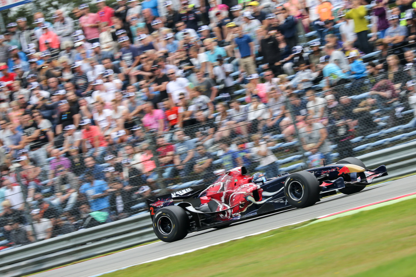 Ingo Gerstl in his STR1-F1 car in front of a packed crowd