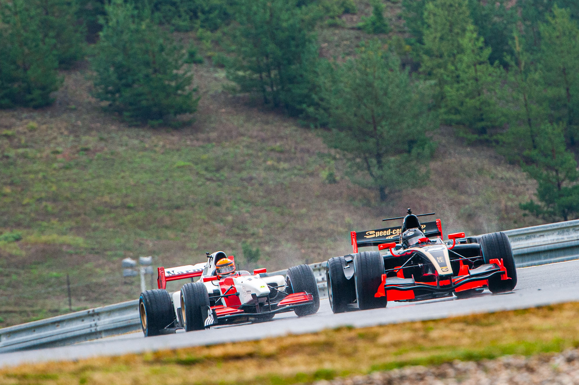 Two BOSS GP cars on wet weather tyres on a slippery track in Brno 2019